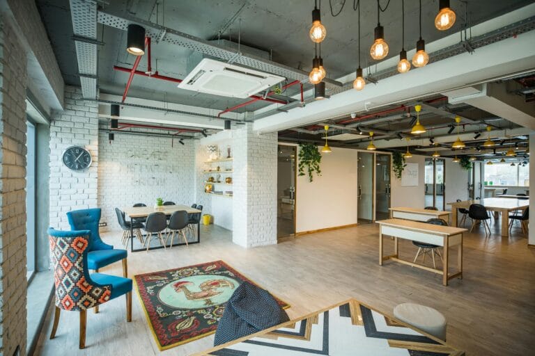 A modern coworking space with bright interiors, stylish furniture, and an open-concept design for productivity.